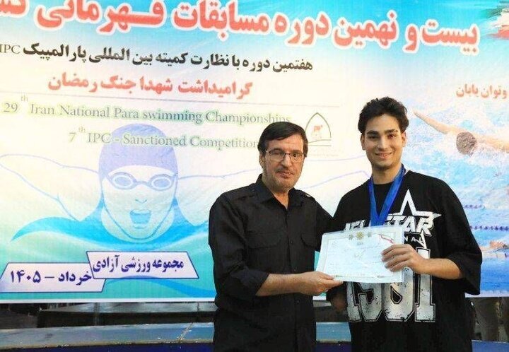 اهدای نشان مسابقات پاراشنا به شناگر جانباز جنگ رمضان